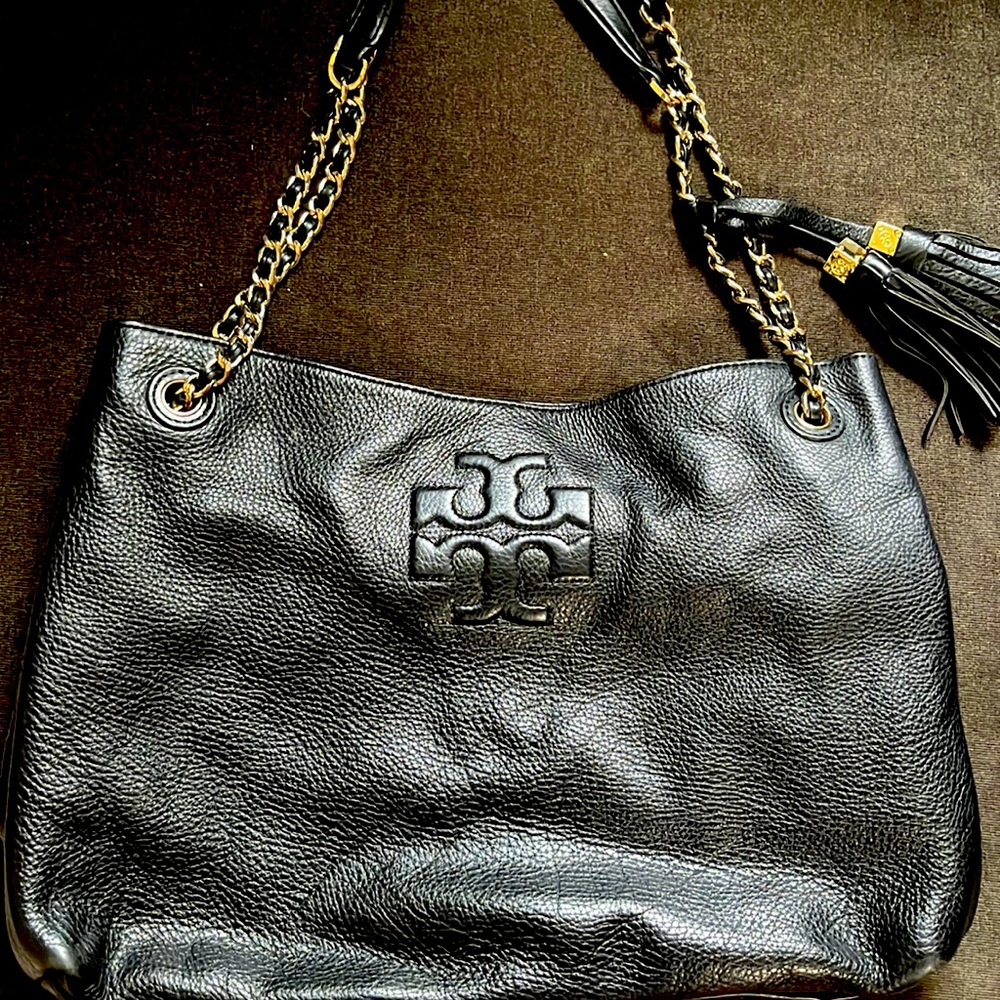 Black leather Tory Burch purse! Gold hardware detail and tassels! Spacious